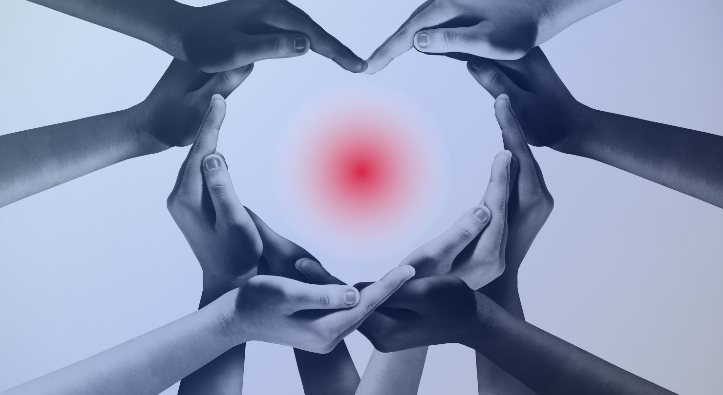 Hands forming a circle around a red point of light